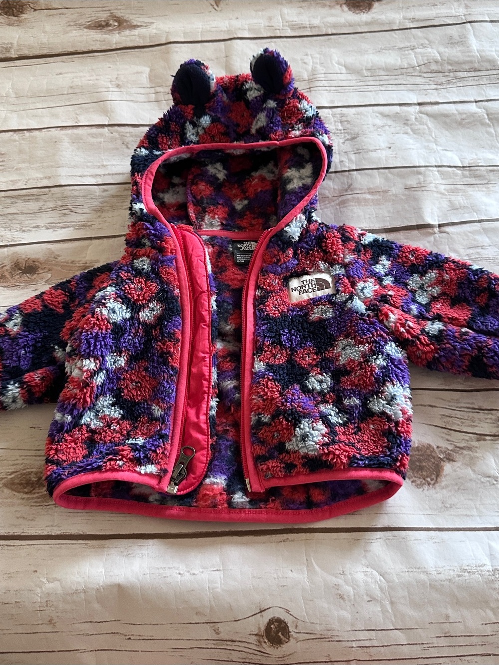 The North Face coral, purple, and white floral fleece hooded sweater